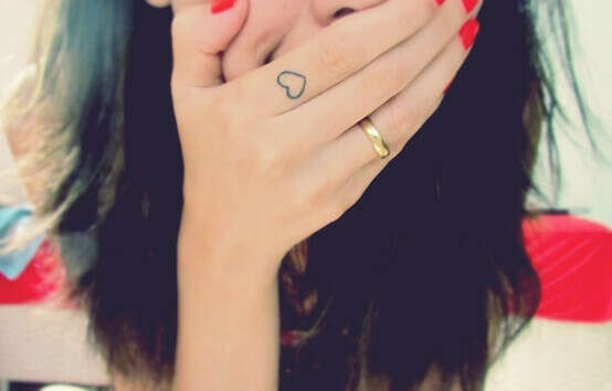 Tattoo heart on finger