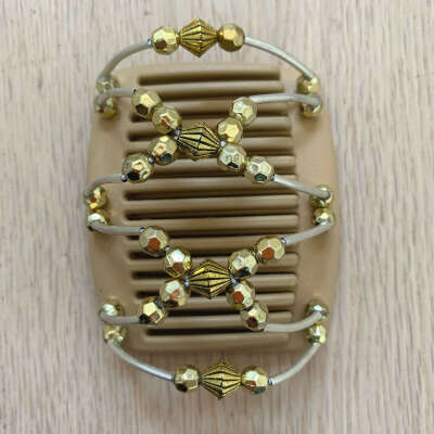 Fine blonde hair comb with gold diamond shaped centre beads with smaller golden decoration